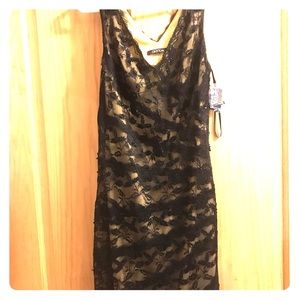 Cocktail length sleeveless black lace dress
